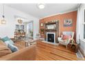 Bright living room with a fireplace and open layout connecting to the dining area at 3059 N Humboldt St, Denver, CO 80205