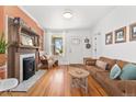 Inviting living room featuring a fireplace, hardwood floors, and ample natural light at 3059 N Humboldt St, Denver, CO 80205