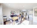 Open dining room with stylish table and seating, seamlessly connected to the kitchen at 66095 E Kettle Pl, Byers, CO 80103