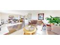 Bright, open-plan living room with hardwood floors and comfortable seating at 66095 E Kettle Pl, Byers, CO 80103