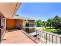 Balcony with wrought iron railing offers views of the street and surrounding greenery at 2682 S Benton St, Lakewood, CO 80227