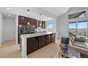 Modern kitchen features a large island, stainless steel appliances, and wood floors for a luxurious design at 7600 Patrick Trl, Elizabeth, CO 80107