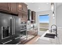 Well-appointed kitchen features stainless appliances, granite countertops, and a large window with views at 7600 Patrick Trl, Elizabeth, CO 80107
