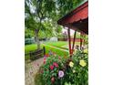 Charming backyard featuring a lush garden, vibrant flowers, and a quaint storage shed at 1325 S Grape St, Denver, CO 80222