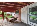 Relaxing covered patio with wood ceiling and outdoor seating area overlooking the yard at 1325 S Grape St, Denver, CO 80222