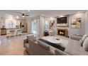 Inviting living room open to the kitchen, with fireplace, and sliding glass doors at 16349 E Radcliff Pl # B, Aurora, CO 80015