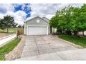 Home exterior features a long driveway and well maintained lawn at 11837 Meadowood Ln, Parker, CO 80138