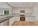 The kitchen has granite counter tops, stainless steel appliances, and wood floors at 11837 Meadowood Ln, Parker, CO 80138