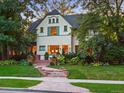 Inviting home exterior with illuminated windows and warm, welcoming curb appeal at 141 N Gilpin St, Denver, CO 80218