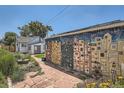 Backyard featuring a patio, lush greenery, and a colorful mural on the garage at 4883 Perry St, Denver, CO 80212
