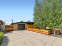 Spacious driveway with an attached garage and a modern horizontal fence surrounding the front yard at 170 W Midway Blvd, Broomfield, CO 80020