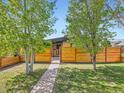 Home featuring a well-manicured front yard, horizontal fence, and a charming entryway path at 170 W Midway Blvd, Broomfield, CO 80020