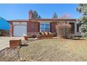 Single story brick home with front yard landscaping and a large shade tree at 1755 S Yampa Way, Aurora, CO 80017