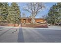 Street view of charming single-story brick home with mature trees and manicured landscaping at 8060 Meade St, Westminster, CO 80031