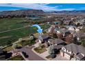 An aerial view showcases a beautiful two-story home with a well-manicured lawn and mountain views at 6271 Mcintyre Way, Golden, CO 80403