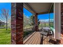 Covered porch featuring comfortable seating and a dining table, perfect for enjoying the outdoor views and fresh air at 6271 Mcintyre Way, Golden, CO 80403