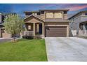 Charming two-story home featuring a well-maintained lawn, covered porch, and a convenient two-car garage in a suburban neighborhood at 1160 Acadia Cir, Erie, CO 80516