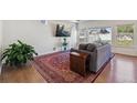 Cozy living room featuring a comfortable sofa, large area rug, and ample natural light, perfect for relaxing and entertaining guests at 1160 Acadia Cir, Erie, CO 80516