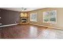 Living room featuring hardwood floors, a cozy fireplace and lots of natural light from the windows at 119 Lake Ave, Palmer Lake, CO 80133