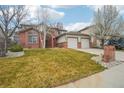 Charming two-story brick home with a well-maintained lawn and two-car garage at 6281 Mcintyre Way, Golden, CO 80403