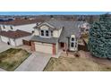 An elevated view showcases this beautiful home's architecture, landscaping, and neighborhood at 5075 Weeping Willow Cir, Highlands Ranch, CO 80130