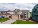 Beautiful exterior of a two-story home with a two-car garage and well-kept lawn at 5075 Weeping Willow Cir, Highlands Ranch, CO 80130