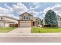 Attractive two-story house with a spacious driveway, two-car garage, and green lawn at 5075 Weeping Willow Cir, Highlands Ranch, CO 80130