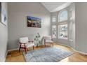 Bright living room featuring a vaulted ceiling, large arched window, and hardwood floors at 5075 Weeping Willow Cir, Highlands Ranch, CO 80130