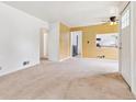 Open living room with great natural light leads into the adjacent dining area and kitchen at 1708 Akron St, Aurora, CO 80010
