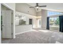 Bright living room features vaulted ceilings, large windows, and open access to the kitchen at 4076 S Carson St # H, Aurora, CO 80014