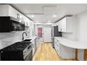 Bright kitchen featuring stainless steel appliances, and white cabinets at 5012 W 36Th Ave # 5, Denver, CO 80212