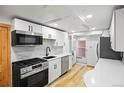 Bright kitchen with stainless steel appliances and white cabinets, with marble backsplashes at 5012 W 36Th Ave # 5, Denver, CO 80212