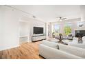 Spacious living room with hardwood floors, a fireplace, a comfortable white sofa, and plenty of natural light at 1699 N Downing St # 302, Denver, CO 80218