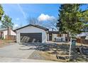 Charming single-Gathering home with a well-maintained lawn, a two car garage, and a cozy front porch at 8334 Allison Ct, Arvada, CO 80005