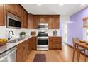 Well-equipped kitchen with stainless steel appliances, wood cabinets, and quartz countertops at 4545 E Harvard Ave, Denver, CO 80222