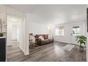 Bright living room with hardwood floors and a view to the kitchen at 7060 W 39Th Ave, Wheat Ridge, CO 80033