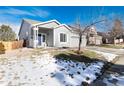 Gray house with a blue door and a partially snow-covered lawn at 3564 S Jebel Cir, Aurora, CO 80013