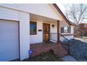 Close-up view of a brick porch and an ornate front door at 3000 S Newland St, Denver, CO 80227