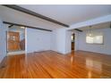Bright living room showcasing hardwood floors and exposed ceiling beams at 3000 S Newland St, Denver, CO 80227