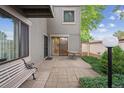 Private outdoor patio featuring a sitting bench, dining table, and sliding glass doors leading inside at 1254 S Yosemite Way # 99, Denver, CO 80247