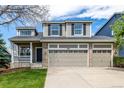 Charming home featuring a two-story facade and an attached three car garage at 1041 Riddlewood Rd, Highlands Ranch, CO 80129