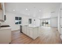 Modern kitchen with quartz island, sleek appliances, and open floor plan at 24739 E 39Th Ave, Aurora, CO 80019