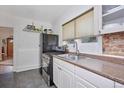 Well-lit kitchen featuring a stainless steel range and ample counter space at 2731 W 32Nd Ave, Denver, CO 80211