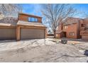 View of the two-car garage with a driveway and landscaping at 2251 E 129Th Ave, Thornton, CO 80241