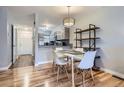 Cozy dining area with modern table and chairs, adjacent to the kitchen, and a decorative shelf at 1818 S Quebec Way # 11-8, Denver, CO 80231