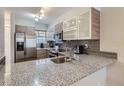Modern kitchen featuring stainless steel appliances, granite counters, and sleek cabinets at 1818 S Quebec Way # 11-8, Denver, CO 80231