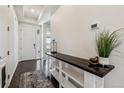 Inviting entryway featuring dark wood floors, a console table, and white walls, creating a bright and welcoming space at 16201 Lanceleaf Pl, Parker, CO 80134
