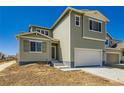 Two-story home featuring a two-car garage and modern architectural details at 4104 Grand Lake St, Brighton, CO 80601