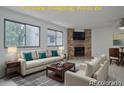 Bright living room features a fireplace and plenty of natural light at 4134 S Fraser Way # E, Aurora, CO 80014