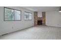 Spacious living room with fireplace and light gray flooring at 4134 S Fraser Way # E, Aurora, CO 80014